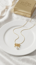 Golden pearl bow pendant
